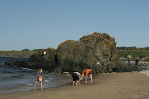 family playing on North Sea Coastline in Berwick Scotland