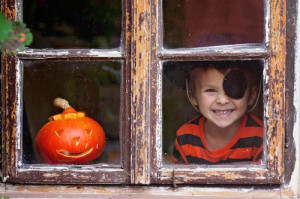 Sweet boy with pumpkin in a costume